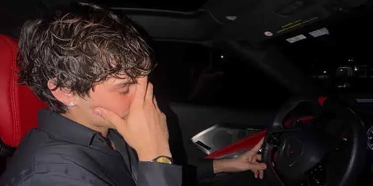 Marco in a car at night